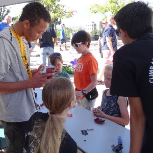 Students inspect robotics components before a competition.